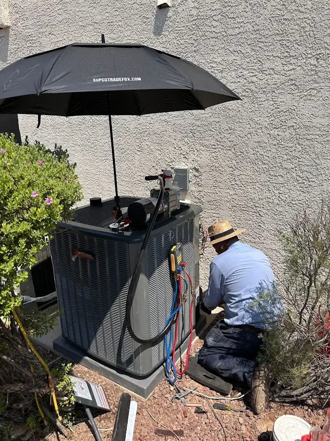 HVAC technician performing outdoor AC maintenance in Delta
