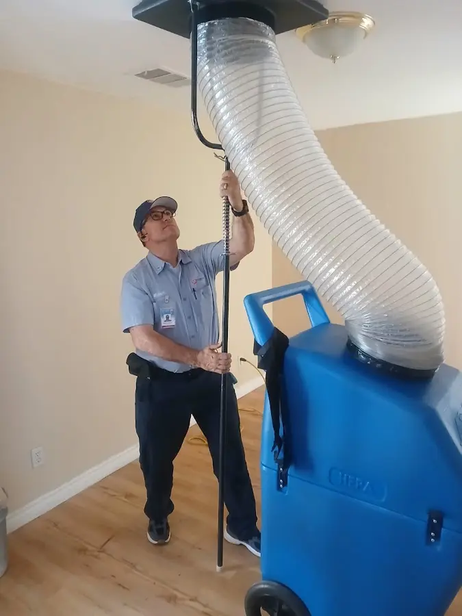 Furnace Tune-Up technician using HEPA equipment in Delta
